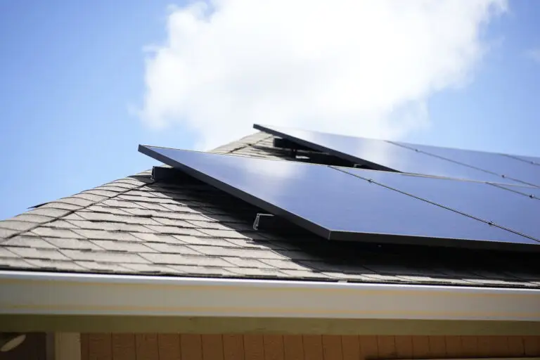 Solar panels installed on well-installed roof. Partly cloudy day in the background. ATTYX Solar