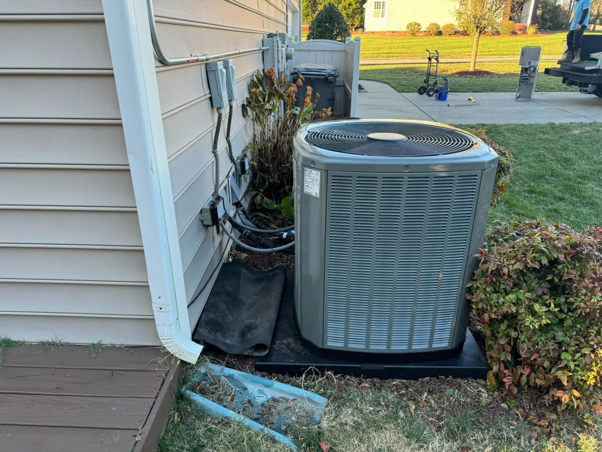 HVAC system next to a house. ATTYX