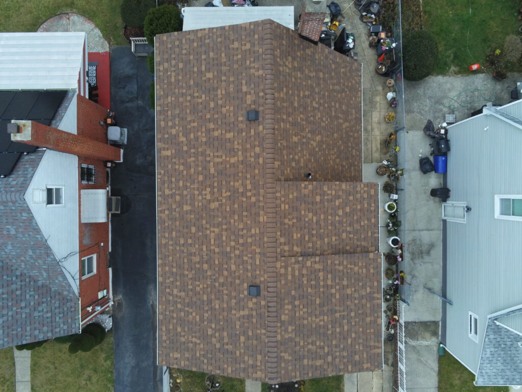looking down on a roof with asphalt shingles. Attyx