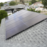 a row of solar panels on a residential roof.